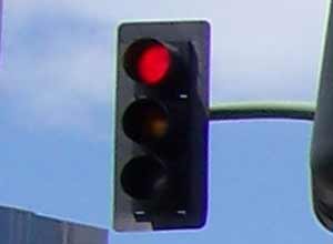 alone motor bike rider on red light traffic signal